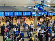 Passengers make their way through a security line Thursday, June 30, 2022, at the Pittsburgh International Airport in Moon Township, Pa. The airport saw an influx of travelers departing Pittsburgh before the Fourth of July holiday weekend.
