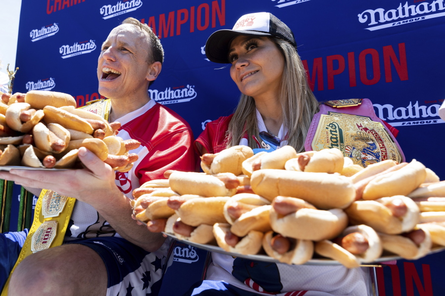 Joey Chestnut and Miki Sudo pose with 63 and 40 hot dogs, respectively, after winning the Nathan's Famous Fourth of July hot dog eating contest in Coney Island on Monday, July 4, 2022, in New York.