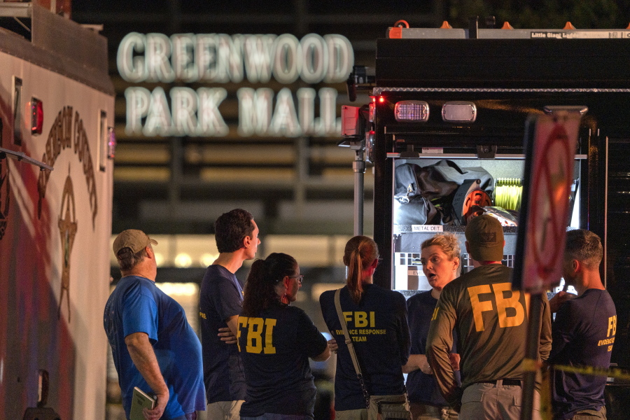 FBI agents gather at the scene of a deadly shooting on Sundayat the Greenwood Park Mall in Greenwood, Ind.