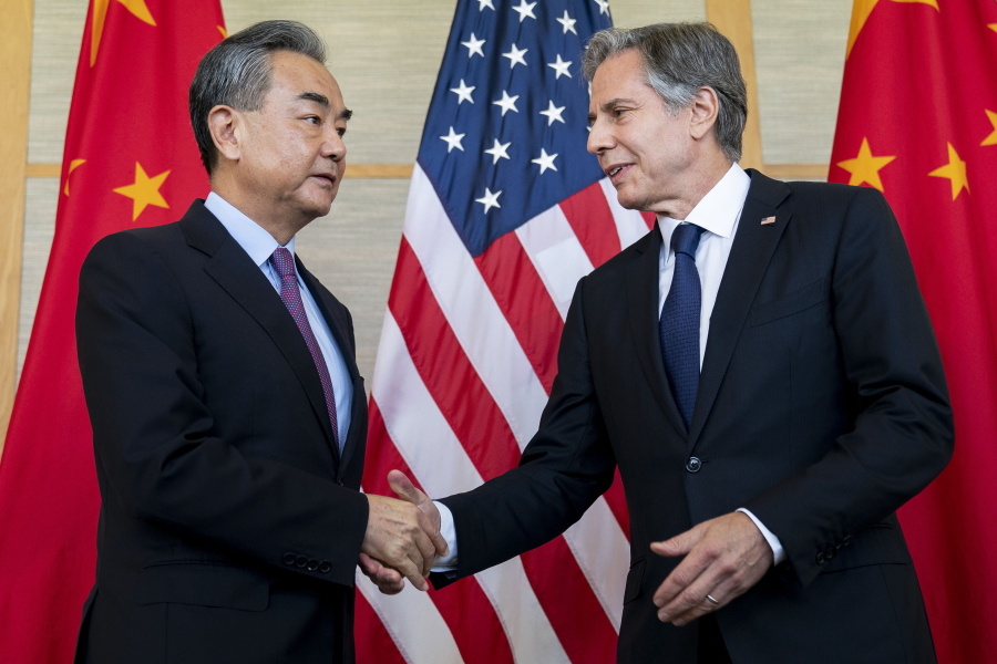 U.S. Secretary of State Antony Blinken, right, shakes hands with China's Foreign Minister Wang Yi during a meeting in Nusa Dua on the Indonesian resort island of Bali Saturday, July 9, 2022.