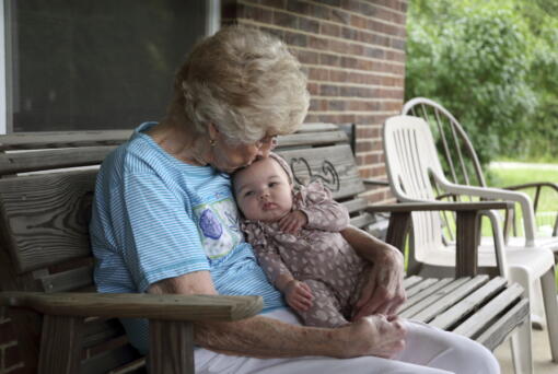 Tressie Corsi sits with her great great granddaughter Amelia Hollis on the porch of the house she has owned in Johnstown, Ohio, since 1972 to that she is giving up to make way for an Intel manufacturing plant during an interview Monday, June 20, 2022. Corsi and her husband raised four children and welcomed multiple generations of grandchildren and great-grandchildren, including some who lived right next door.