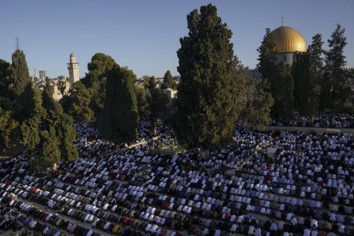 Muslim worshipers offer Eid al-Adha prayers next to the Dome of the Rock shrine at the Al Aqsa Mosque compound in Jerusalem's Old City, Saturday, July 9, 2022. The major Muslim holiday, at the end of the hajj pilgrimage to Mecca, is observed around the world by believers and commemorates prophet Abraham's pledge to sacrifice his son as an act of obedience to God.