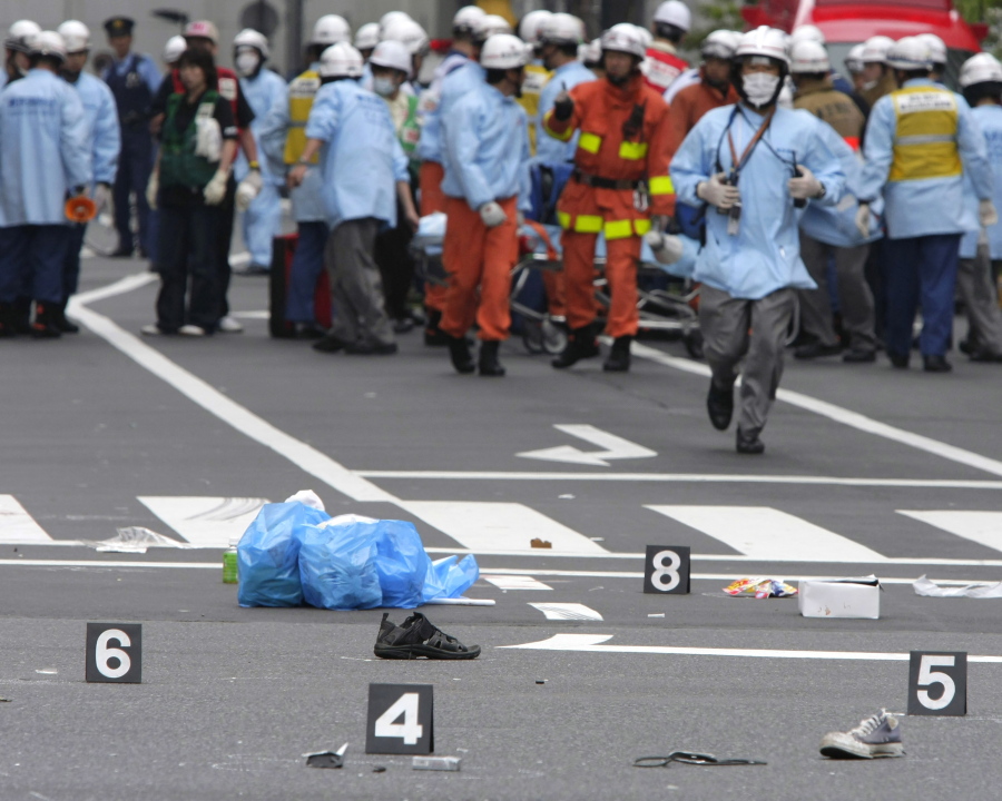 FILE - Shoes of victims are left on a street as rescuers from the Tokyo Metropolitan Police Department work in Tokyo's Akihabara district after a man rammed a truck into a crowd of shoppers, jumped out and went on a stabbing spree in Tokyo's top electronics district on June 8, 2008. Japan on Tuesday, July 26, 2022 executed a man convicted of killing seven in the 2008 rampage in Tokyo's Akihabara electronics district, the justice minister announced.