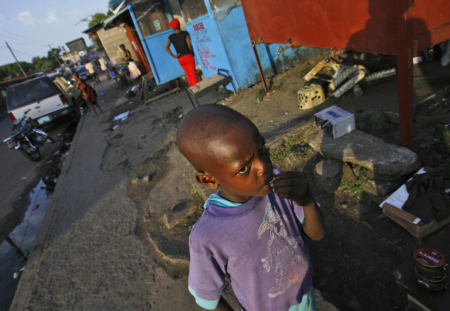 FILE - A young boy stands in the streets of Monrovia, Liberia, Nov. 20, 2007. Liberia is celebrating two major anniversaries this year -- 200 years ago freed slaves from the U.S. arrived here and 25 years later they declared the country to be independent. Amid the festivities for Independence Day on Tuesday July 26, 2022, many Liberians say the West African country's promise is unfulfilled and too many of its people still live in poverty.