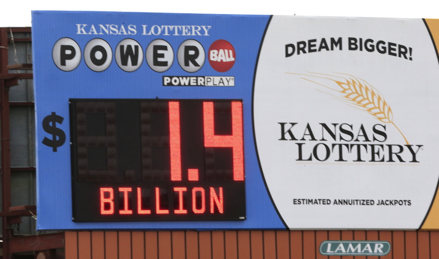 FILE - A record Powerball jackpot is posted on a Kansas Lottery billboard in Topeka, Kan., on Monday, Jan. 11, 2016. State lotteries spend more than a half-billion dollars a year on pervasive marketing campaigns that deliver hopeful messages, designed to persuade people to play often, spend more and overlook the long odds of winning. But for every dollar players spend on the lottery, they will lose about 35 cents on average, according to an analysis in 2021 of lottery data by the Howard Center for Investigative Journalism at the University of Maryland.
