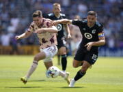 Portland Timbers forward Jaros?aw Niezgoda (11) and Minnesota United defender Michael Boxall (15) battle for possession during the second half of an MLS soccer match at Allianz Field in Saint Paul, Minn., Saturday, July 30, 2022.