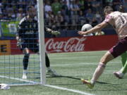 Portland Timbers forward Jaroslaw Niezgoda, right, heads the ball in for a goal against Seattle Sounders goalkeeper Stefan Frei, left, during the first half of an MLS soccer match, Saturday, July 9, 2022, in Seattle. (AP Photo/Ted S.