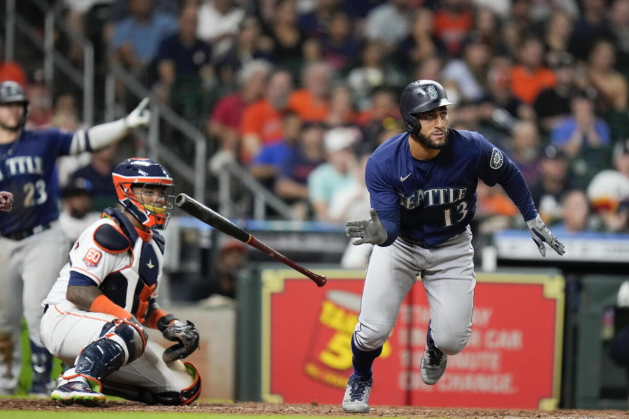 Seattle Mariners' Abraham Toro (13) watches his two-run single during the ninth inning of the team's baseball game against the Houston Astros, Saturday, July 30, 2022, in Houston.
