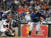 Seattle Mariners' Abraham Toro (13) watches his two-run single during the ninth inning of the team's baseball game against the Houston Astros, Saturday, July 30, 2022, in Houston.