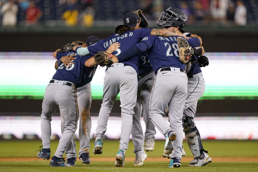 Members of the Seattle Mariners celebrate after winning the second game of a baseball doubleheader against the Washington Nationals, Wednesday, July 13, 2022, in Washington. Seattle won 2-1.