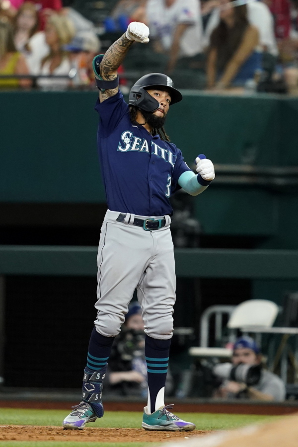 Seattle Mariners' J.P. Crawford celebrates hitting an RBI single during the 10th inning of the team's baseball game against the Texas Rangers, Saturday, July 16, 2022, in Arlington, Texas. The Mariners won 3-2.
