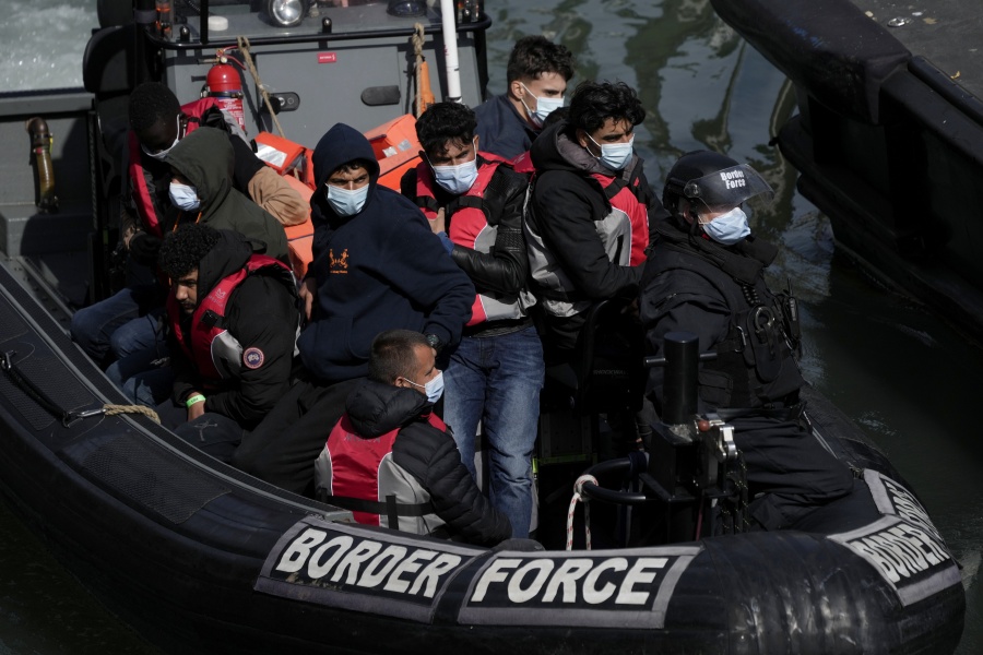 FILE - People thought to be migrants who undertook the crossing from France in small boats and were picked up in the Channel, arrive to be disembarked from a small transfer boat which ferried them from a larger British border force vessel, in Dover, south east England, Friday, June 17, 2022. The suspected ringleader of a network that smuggled as many as 10,000 people on small boats across the English Channel to Britain has been arrested along with 38 others in a vast police operation across Europe, authorities said Wednesday, July 6, 2022.