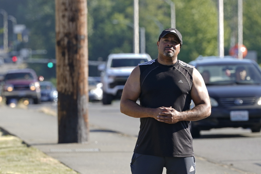 Dominique Davis, founder of Community Passageways, an organization that seeks to prevent community violence, poses for a photo, Tuesday, July 12, 2022 on Pacific Highway South, in Kent, Wash., south of Seattle, a roadway that Davis says has had multiple problems with shootings and other crimes for many years. The work of Davis' group falls under the umbrella of strategies known as community violence intervention, an approach backed by the Biden administration and donations from several major philanthropic foundations, which tries to stop local conflicts from escalating. (AP Photo/Ted S.