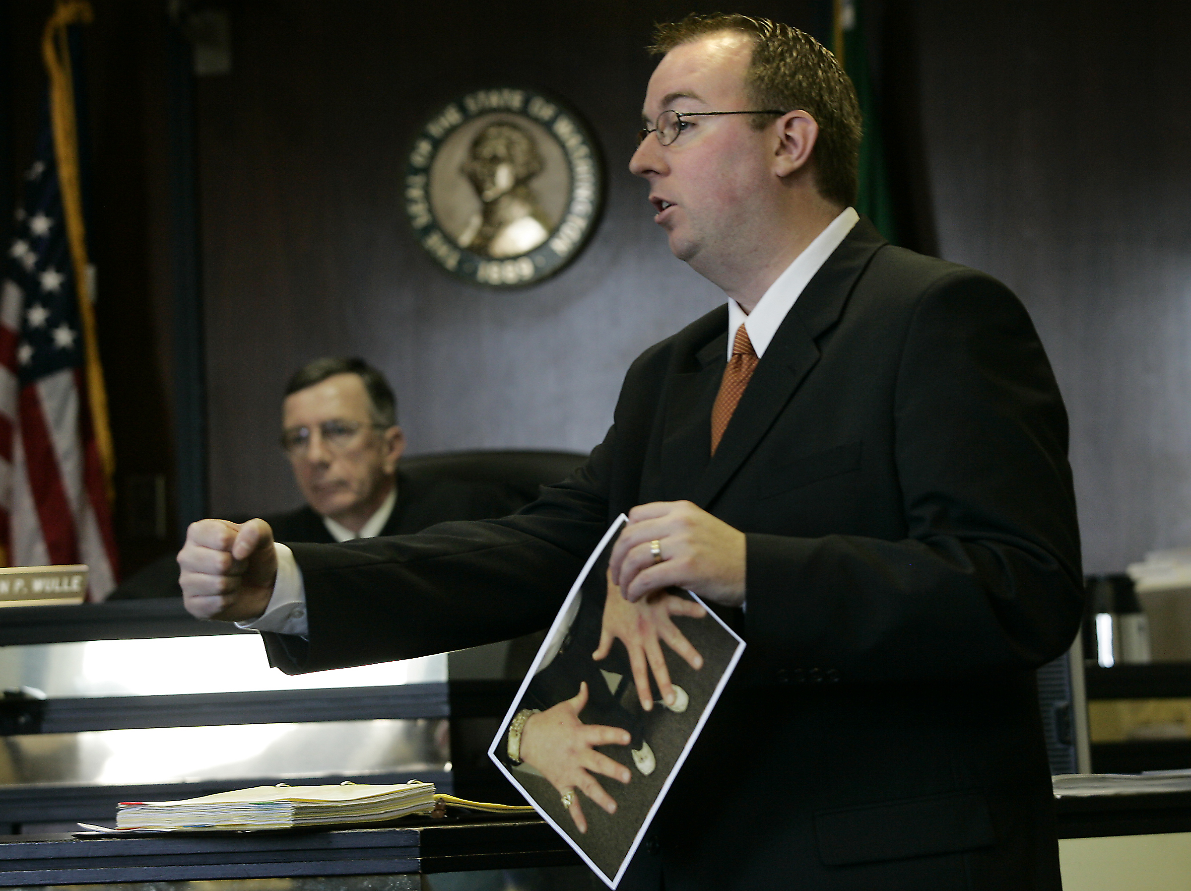 January 24 , 2005 -- Jeremiah Coughlan -- Deputy prosecutor James Senescu makes the case for preponderance of small pieces of testimony and evidence forming a large picture that gives motive and means to convicting Roy Russell in the death of Chelsea Harrison, 14, found in a basement shower of Russell's duplex 4010 Daniels St. November 1, 2005.  Senescu gestures how one piece, Chelsea defending herself by hitting Russell with her right fist, causing bruises to Russell's left torso, and scraping his left hand, which was over her mouth, with her left hand where his DNA was found.