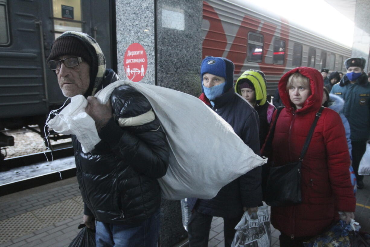 People from Mariupol and eastern Ukraine disembark from a train at the railway station in Nizhny Novgorod, Russia, Thursday, April 7, 2022, to be taken to temporary residences in the region. About 500 refugees from the Mariupol area arrived in Nizhny Novgorod on a special train organized by Russia from eastern Ukraine, about 500 miles (800 kilometers) from the border.
