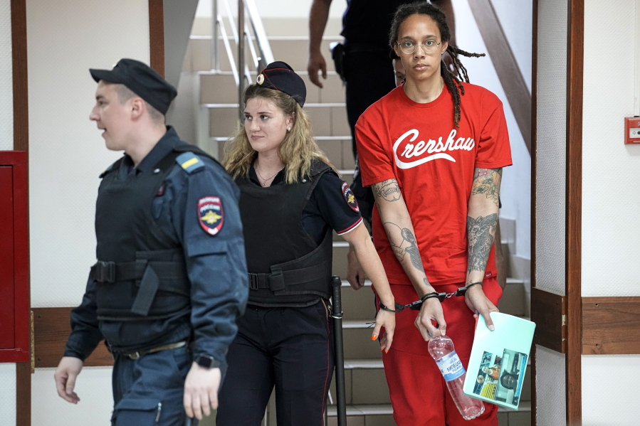 WNBA star and two-time Olympic gold medalist Brittney Griner is escorted to a courtroom for a hearing, in Khimki just outside Moscow, Russia, Thursday, July 7, 2022. Jailed American basketball star Brittney Griner returns to a Russian court on Thursday amid a growing chorus of calls for Washington to do more to secure her release nearly five months after being arrested on drug charges.