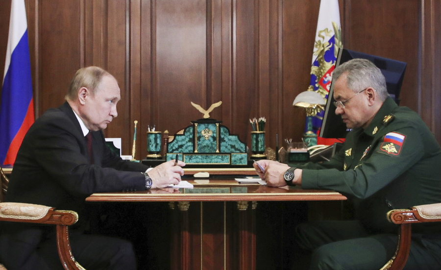 Russian President Vladimir Putin listens to Russian Defense Minister Sergei Shoigu's report during their meeting in the Kremlin in Moscow, Russia, Monday, July 4, 2022.