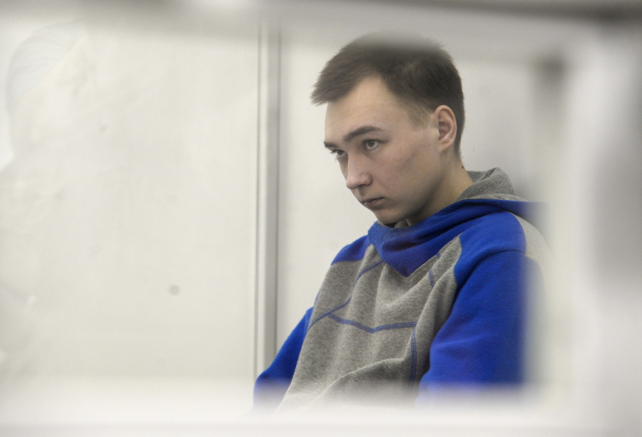Russian army Sergeant Vadim Shishimarin, 21, is seen behind a glass during a court hearing in Kyiv, Ukraine, Monday, July 25, 2022. Kyiv Appeal court has started to consider an appeal on a life sentence for Shishimarin after he was sentenced for the killing of a 62-year-old man who was shot in the head in a village in the northeastern Sumy region in the opening days of the war.