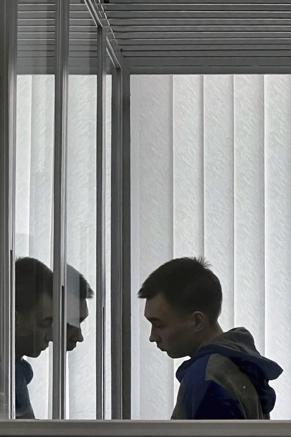 Russian soldier Vadim Shishimarin looks on during his appeal hearing at a court in Kyiv, Ukraine, Friday July 29, 2022. An appeals court in Kyiv has reduced to 15 years the life sentence of Shishimarin, a 21-year-old contract soldier convicted in the first war crimes trial since Russia invaded Ukraine in February.