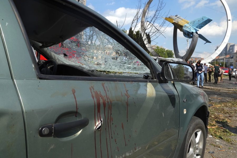 FILE - Blood stains are seen on a damaged car after a deadly Russian missile attack in Vinnytsia, Ukraine, July 14, 2022. As Russia's war in Ukraine rages on, the Kremlin is expanding its information war throughout Eastern Europe, spreading propaganda and disinformation blaming NATO and the West for its Ukraine invasion.