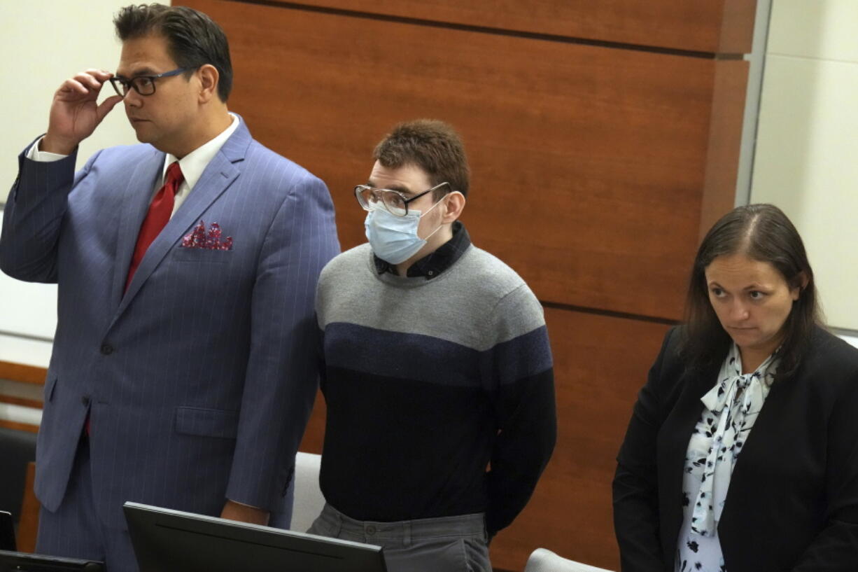 Marjory Stoneman Douglas High School shooter Nikolas Cruz stands with Chief Assistant Public Defender David Wheeler and sentence mitigation specialist Kate O'Shea, during the penalty phase of Cruz's trial at the Broward County Courthouse in Fort Lauderdale on Wednesday, July 27, 2022. Cruz previously plead guilty to all 17 counts of premeditated murder and 17 counts of attempted murder in the 2018 shootings.