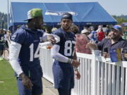Seattle Seahawks wide receiver DK Metcalf, left, walks with tight end Noah Fant (87) after practice at NFL football training camp Thursday, July 28, 2022, in Renton, Wash. (AP Photo/Ted S.