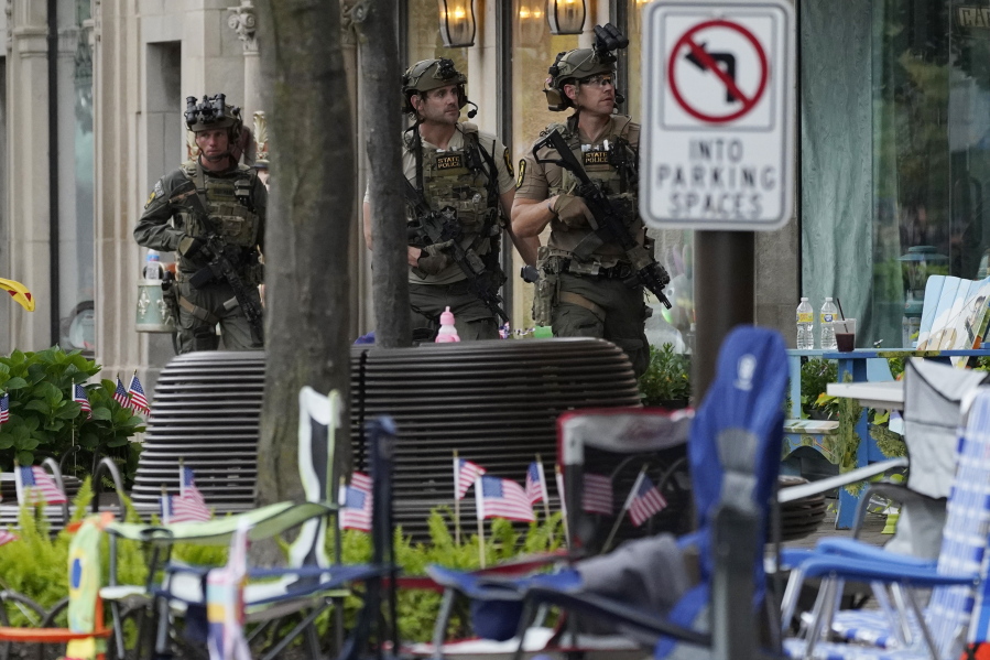 Law enforcement search after a mass shooting at the Highland Park Fourth of July parade in downtown Highland Park, Ill., a Chicago suburb on Monday, July 4, 2022. (AP Photo/Nam Y.