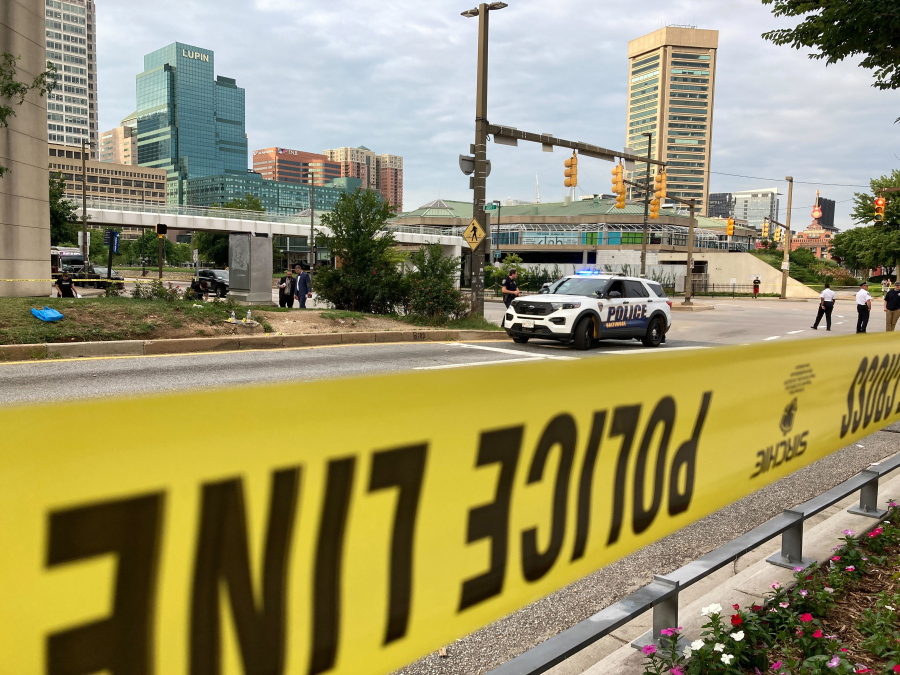 Forensics team gather and collect evidence at the scene of a shooting on Conway St. at the intersection of light Street across from Harborplace Thursday, July 7, 2022 in Baltimore.