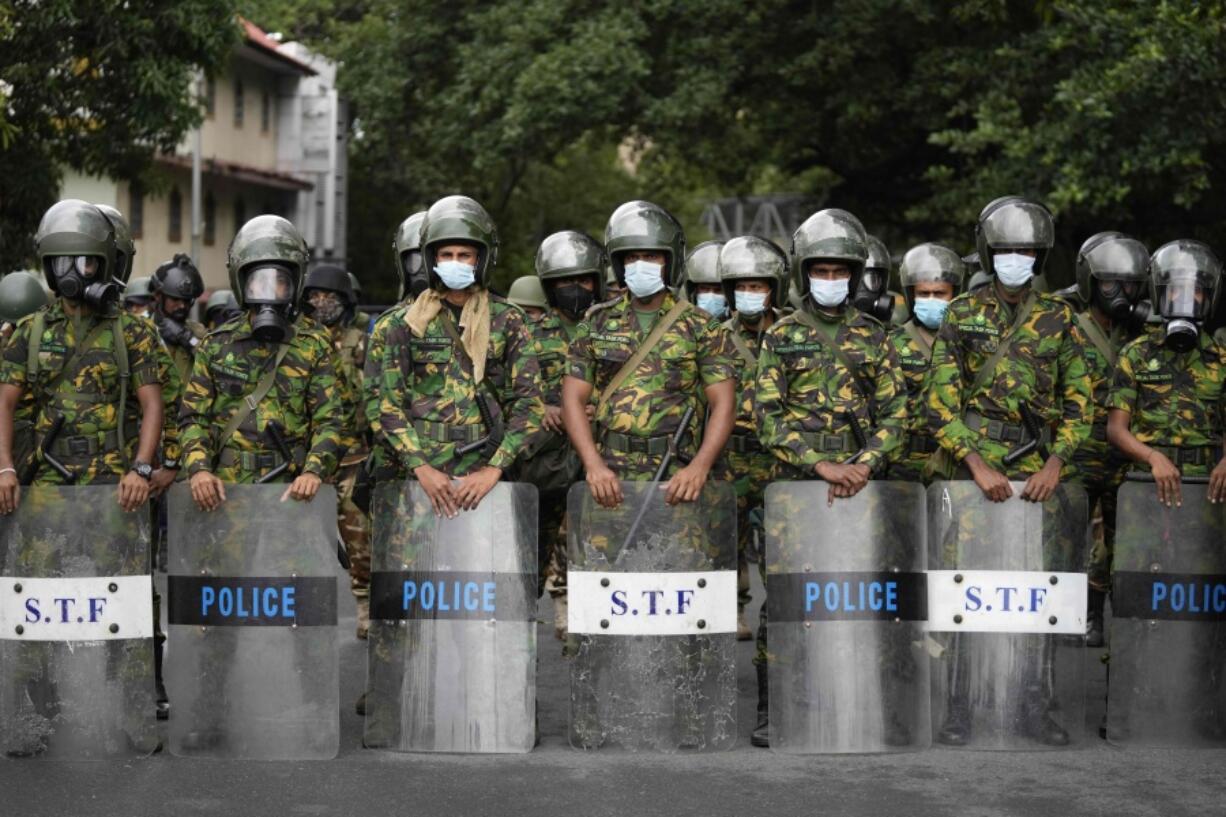 Police commandos stand guard at a barricade outside president's office in Colombo, Sri Lanka, Friday, July 22, 2022.