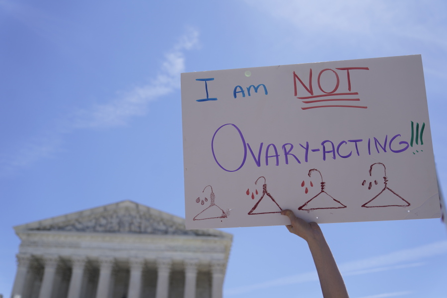 An abortion-rights activists holds a sign reading "I am not Ovary-Acting," during the protests outside of the U.S. Supreme Court, on Tuesday, June 28, 2022, in Washington.