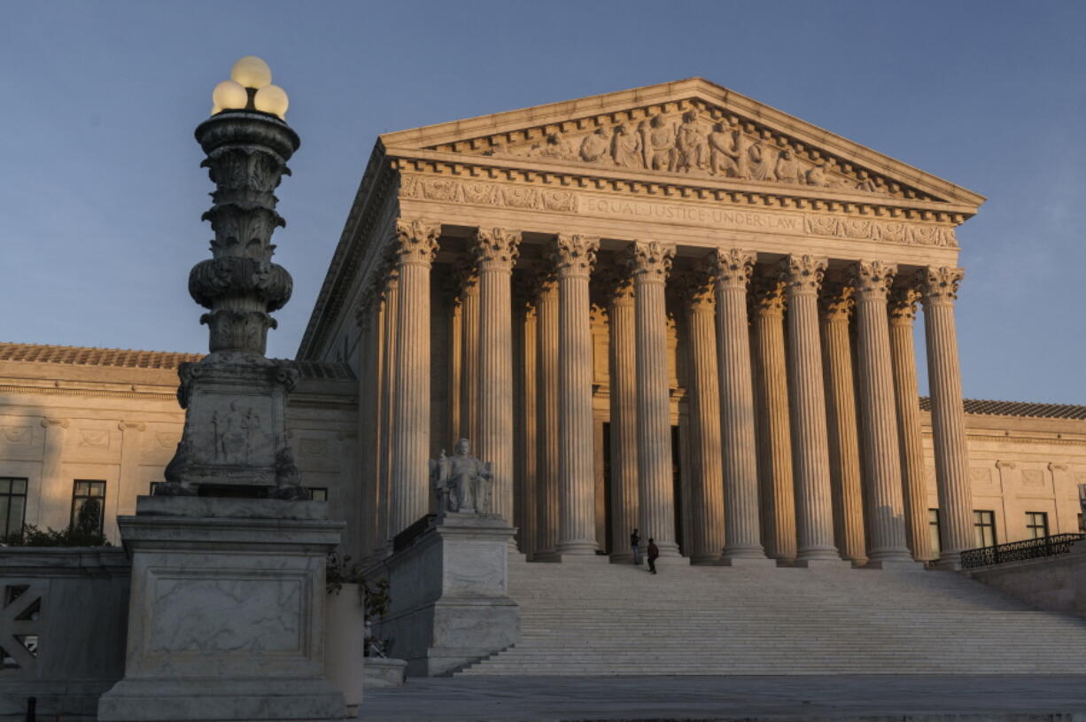 FILE - The Supreme Court is seen at sundown in Washington, on Nov. 6, 2020. The Supreme Court won't allow the Biden administration to implement a policy that prioritizes deportation of people in the country illegally who pose the greatest public safety risk. The court's order on July 21, 2022, leaves the policy frozen nationwide for now. (AP Photo/J.