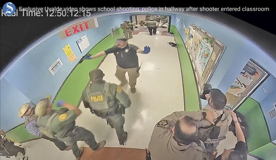 FILE - In this photo from surveillance video provided by the Uvalde Consolidated Independent School District via the Austin American-Statesman, authorities respond to the shooting at Robb Elementary School in Uvalde, Texas, on May 24, 2022. Nearly 400 law enforcement officials rushed to the mass shooting that left 21 people dead at the elementary school but "systemic failures" created a chaotic scene that lasted more than an hour before the gunman was finally confronted and killed, according to a report from investigators released Sunday, July 17, 2022.