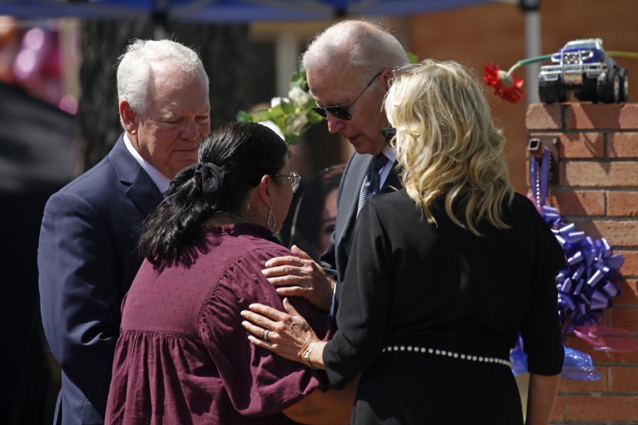 FILE - President Joe Biden and first lady Jill Biden comfort principal Mandy Gutierrez as superintendent Hal Harrell stands next to them, at the memorial outside Robb Elementary School to honor the victims killed in this week's school shooting in Uvalde, Texas, on May 29, 2022. The attorney for the principal of the Texas elementary school where a gunman killed 19 students and two teachers says Gutierrez has been placed on administrative leave on Monday, July 25.
