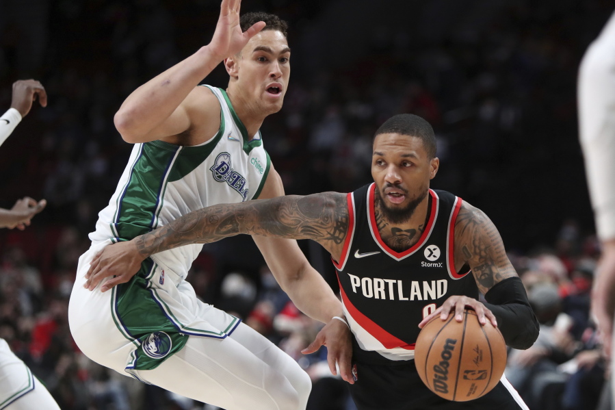Portland Trail Blazers guard Damian Lillard, right, has a new contract with the team he has spent his entire NBA career with, and that is a point of pride for the six-time All Star.