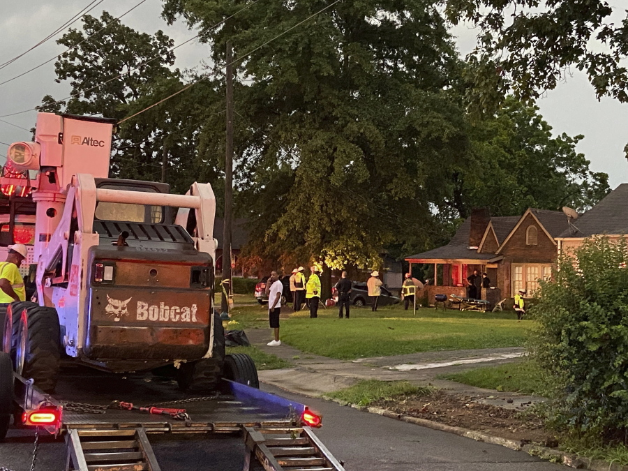 Birmingham Fire and Rescue Service respond to a home after a tree fell after a storm on Thursday, July 21, 2022 in Birmingham, Ala.  Battalion Chief Sebastian Carrillo said they arrived to find the massive tree had smashed into the brick home.