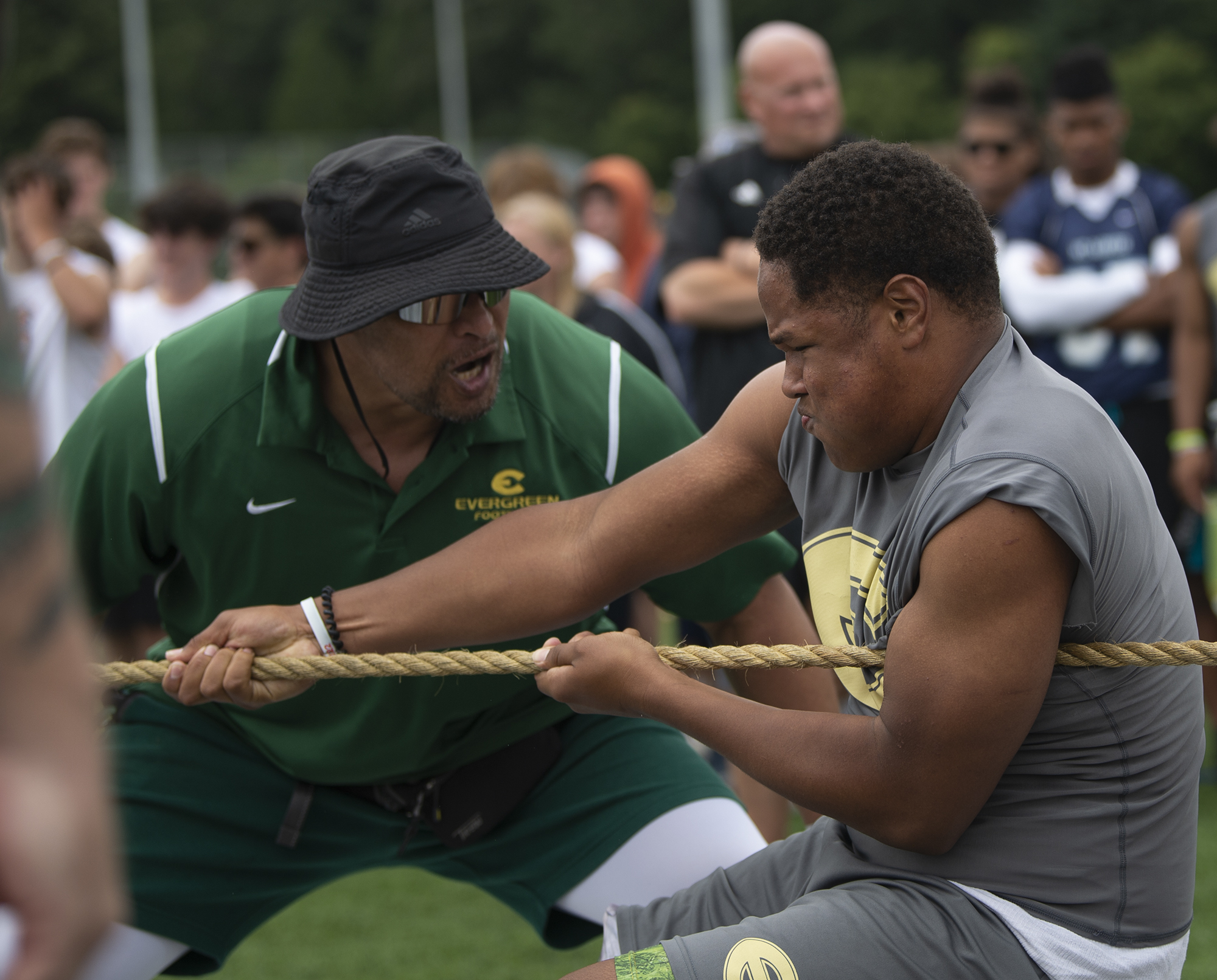 Evergreen assistant coach Tafiko Salu urges on Mahki Miller during the tug-o-war at the Rumble at the River 7-on-7 Tournament and Linemen Challenge at Union High School on Saturday, July 23, 2022.