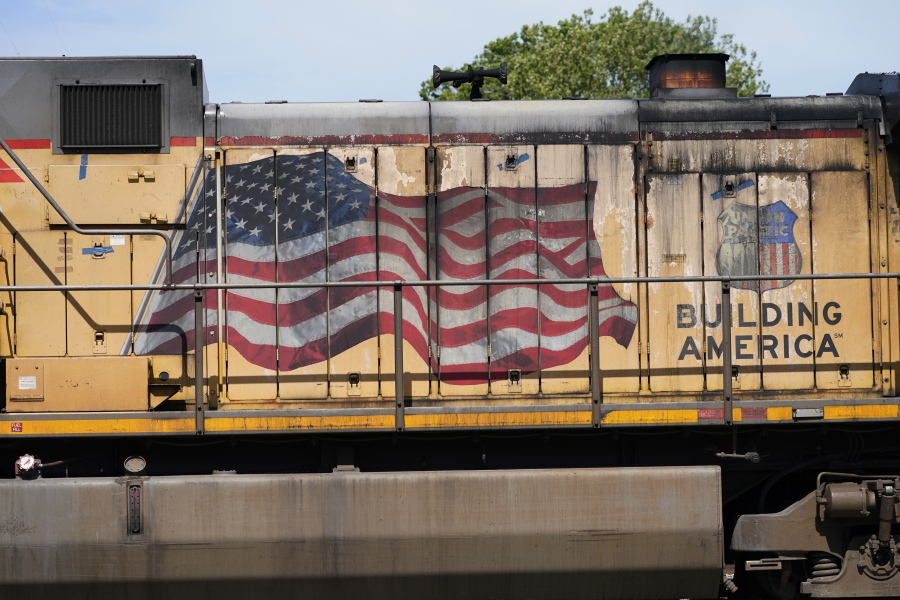 FILE - An American flag is emblazoned on this Union Pacific Railroad locomotive sitting in the Jackson, Miss., terminal rail yard, Wednesday, April 20, 2022.   Union Pacific's second-quarter profit improved a bit, but the railroad's expenses jumped as it tried to reduce the delivery delays that have left its customers waiting for trains at times. The railroad said Thursday, July 21,  that its profit grew 2% to $1.84 billion, or $2.93 per share.  (AP Photo/Rogelio V.