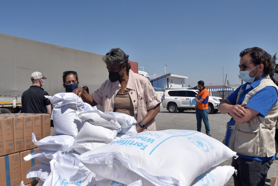 FILE - In this photo provided by the US Embassy in Turkey, Linda Thomas-Greenfield, U.S. Ambassador to the United Nations, examines aid materials at the Bab al-Hawa border crossing between Turkey and Syria, June 3, 2021. Supporters of a one-year extension of humanitarian aid deliveries from Turkey to 4.1 million Syrians in the rebel-held northwest, which Russia vetoed, are calling on Monday, July 11, 2022 for a Security Council vote on Moscow's proposal for a six-month extension.