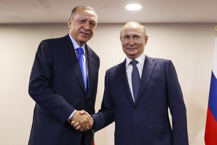 FILE - In this handout photo provided by the Turkish Presidency, Turkish President Recep Tayyip Erdogan, left, shakes hands with Russian President Vladimir Putin during their meeting, in Tehran, Iran, July 19, 2022. The Biden administration likes to say that Russia is now isolated internationally because of its invasion of Ukraine. Yet its top officials are hardly sitting lonely and isolated in the Kremlin and now the U.S.