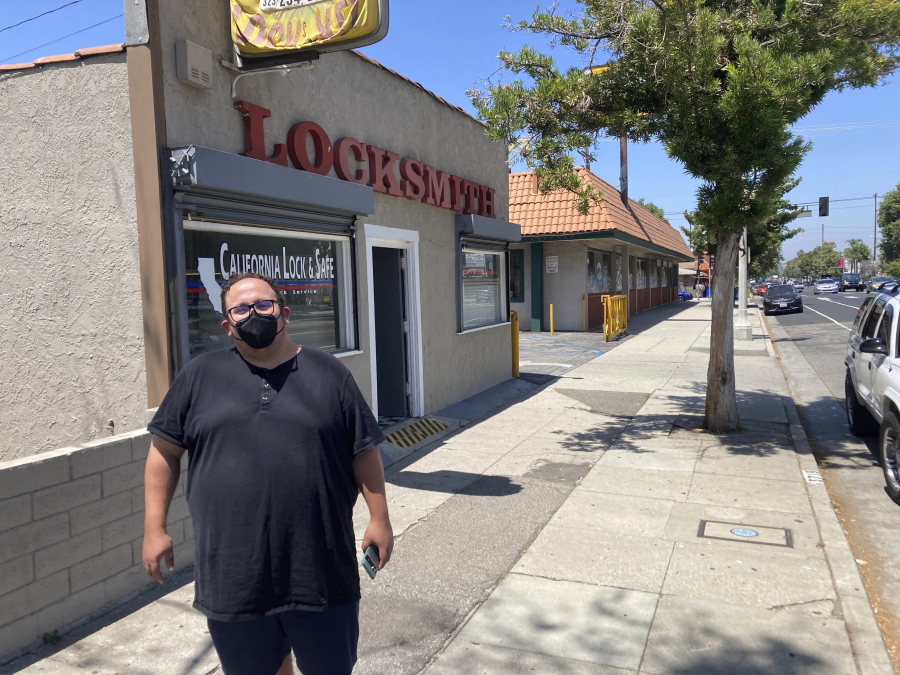 Nick Barragan wears a mask while running errands in Los Angeles on Wednesday, July 13, 2022. Los Angeles County is facing a return to a broad indoor mask requirement if current trends in hospital admissions continue, health officials said. Barragan said he's disappointed that the fast spread of COVID-19 could mean the return of a mandate, but he's used to wearing a mask because it's always been required for his job in film production.
