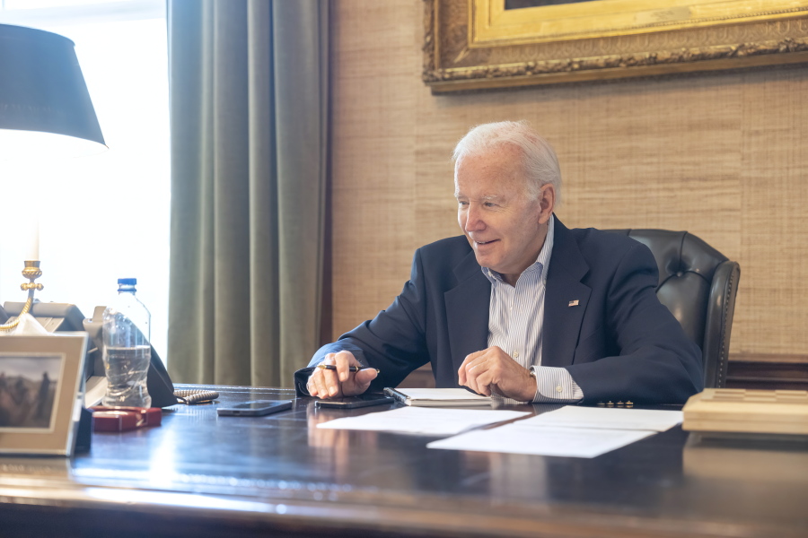 In this image provided by the White House, President Joe Biden speaks with Sen. Bob Casey, D-Pa., on the phone from the Treaty Room in the residence of the White House Thursday, July 21, 2022, in Washington. Biden says he's "doing great" after testing positive for COVID-19. The White House said Biden is experiencing "very mild symptoms," including a stuffy nose, fatigue and cough. He's taking Paxlovid, an antiviral drug designed to reduce the severity of the disease.