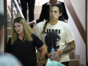 WNBA star and two-time Olympic gold medalist Brittney Griner is escorted to a courtroom for a hearing, in Khimki just outside Moscow, Russia, Friday, July 1, 2022. U.S. basketball star Brittney Griner is set to go on trial in a Moscow-area court Friday. The proceedings that are scheduled to begin Friday come about 4 1/2 months after she was arrested on cannabis possession charges at an airport while traveling to play for a Russian team.
