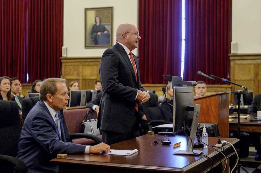 Attorney Paul T. Ferrell Jr. asks West Virginia Circuit Court Judges Alan Moats and Derick Swope for a continuance in the opioid trial scheduled to begin Tuesday, July 5, 2022, in the Kanawha County Ceremonial Courtroom in Charleston, W.Va. Lawyer Bob Fitzsimmons sits at the table to Ferrell's right.