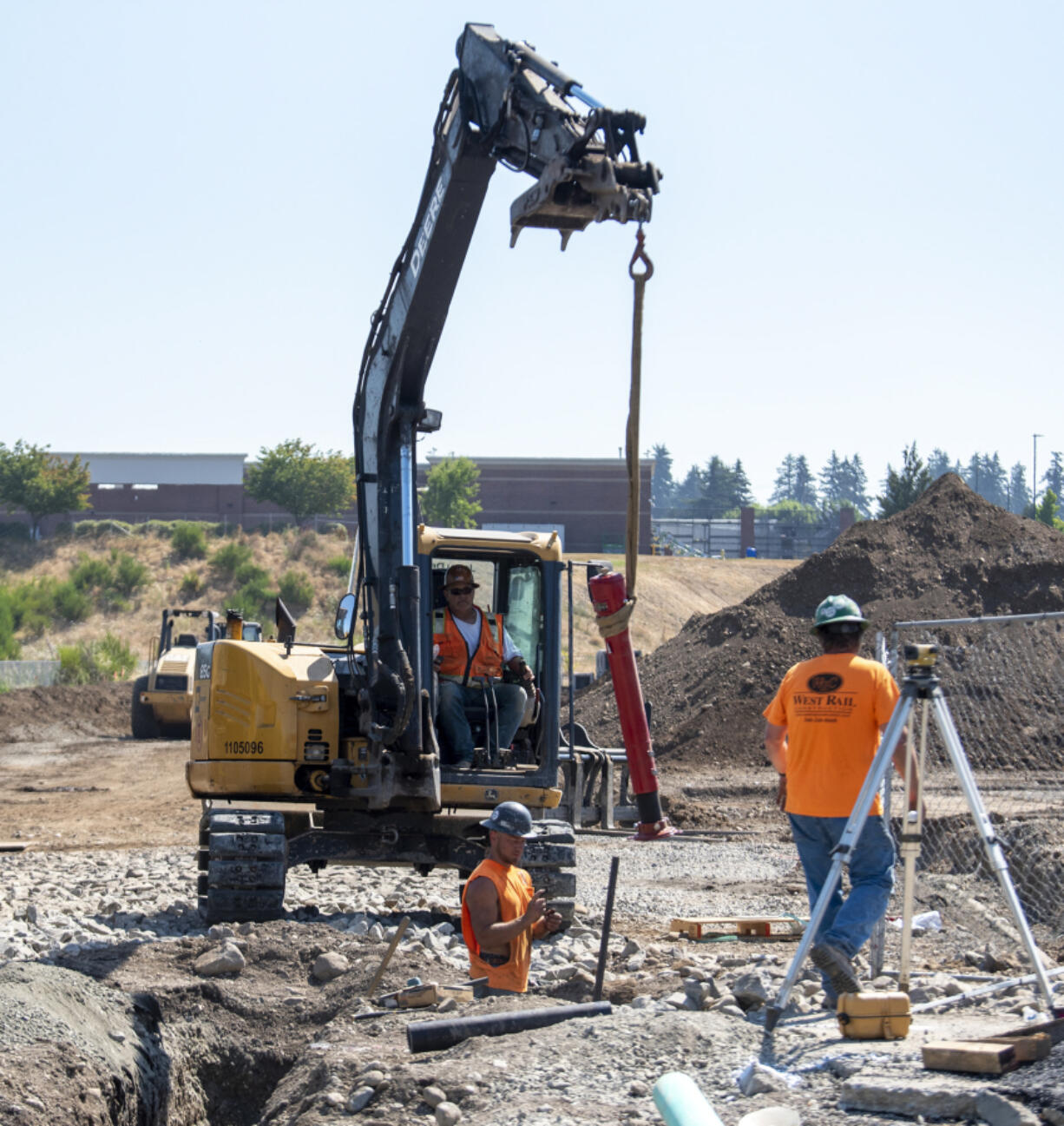 Tapani Inc. workers install a fiber line at a future transit center site on Southeast 184th Avenue. C-Tran is laying roughly $4 million worth of fiber along the entire corridor to enhance communication between bus stations and ensure that travel times are more reliable.
