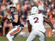 Auburn quarterback Bo Nix (10) throws a pass as Mississippi State linebacker Tyrus Wheat (2) brings pressure during the first half of an NCAA college football game Saturday, Nov. 13, 2021, in Auburn, Ala.
