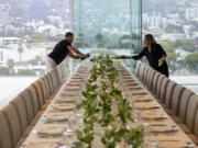 Wine is poured as staff members prepare a five-course dinner during a VIP event at 8899 Beverly, one of the most exclusive condo residences ever built, on June 15, 2022, in West Hollywood, California.