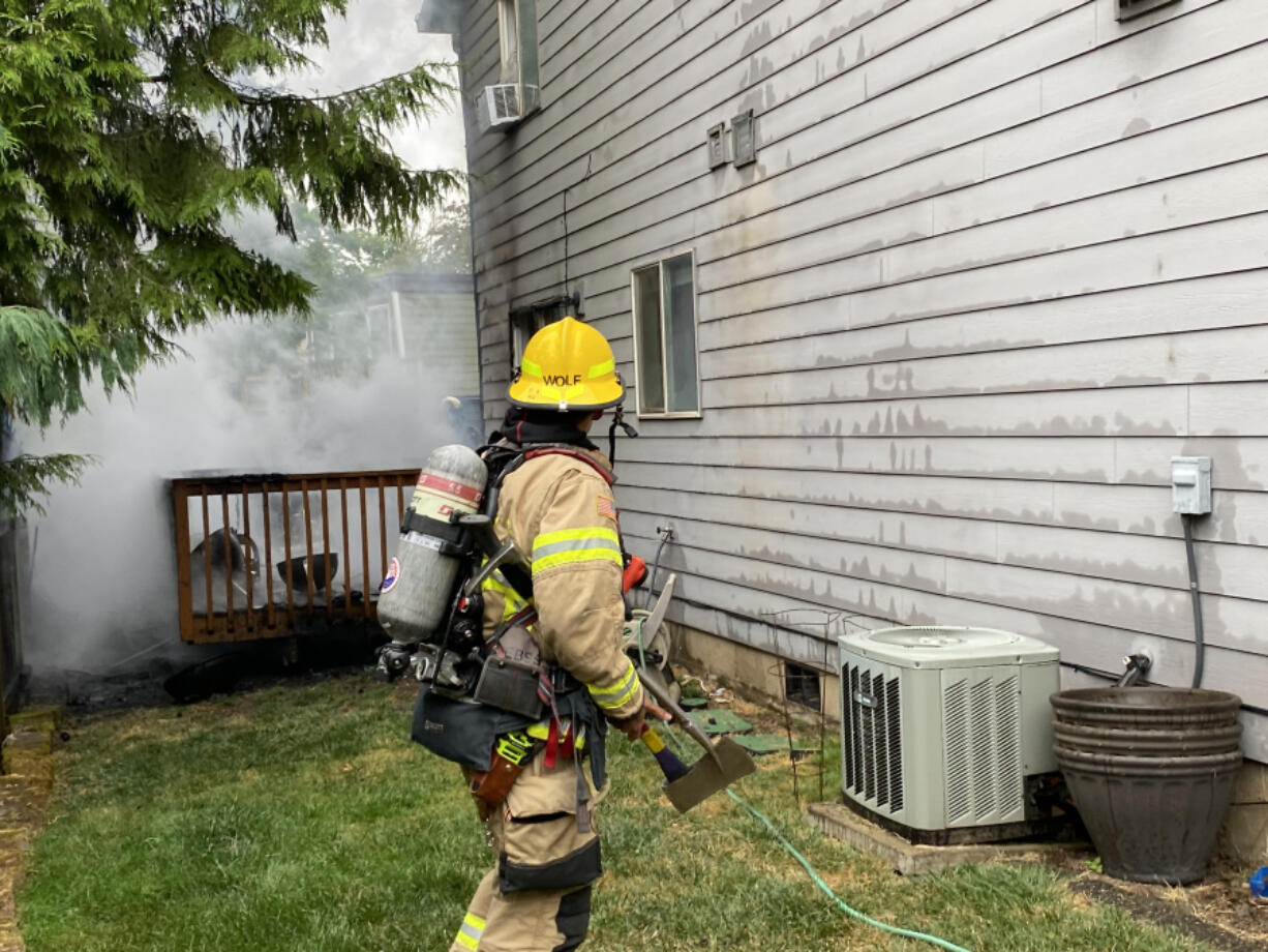 Smoke rises from a deck fire Wednesday morning in Hazel Dell. Clark County Fire District 6 and Vancouver firefighters extinguished the blaze in about 10 minutes.