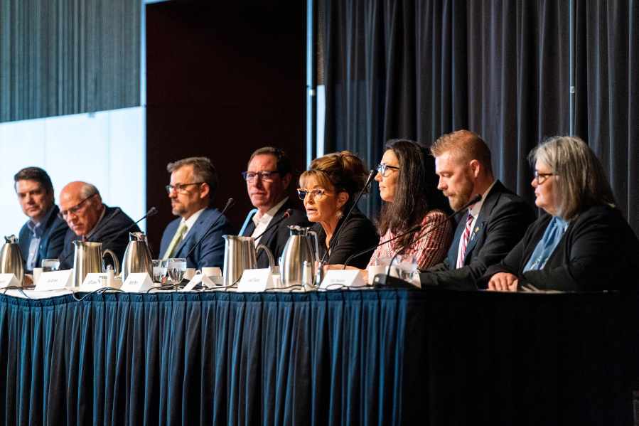 In May, candidates for U.S. Congress participated in a debate hosted by the Alaska Chamber, Alaska Miners Association and other organizations in Anchorage, Alaska. From left are Nick Begich, John Coghill, Christopher Constant, Al Gross, Jeff Lowenfels (not visible), Sarah Palin, Mary Peltola, Josh Revak and Tara Sweeney. The field has since been narrowed to three: Begich, Palin and Peltola.