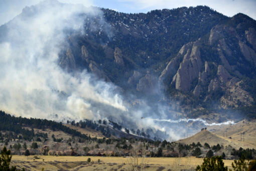 In this photo from March 26, 2022, a single-engine air tanker drops water on the NCAR fire as it burns in the foothills south of the National Center for Atmospheric Research in Boulder, Colorado. The NCAR fire prompted evacuations in south Boulder and a pre-evacuation warning for Eldorado Springs. The wildfire broke out near the National Center for Atmospheric Research in southwestern Boulder on Saturday afternoon, prompting evacuation orders for parts of the city and pre-evacuation notices for Eldorado Springs, according to authorities. Boulder police initially said about 1,200 residences had been ordered to evacuate due to what has been named the NCAR fire. But a short time later, police tweeted a map that showed nearly all of south Boulder under evacuation. The Boulder Office of Emergency Management now says that the map was wider than required and that the actual evacuation area is "from NCAR to Baseline Road, east to U.S. 36, back down to Broadway, and straight west to NCAR again." (Helen H.