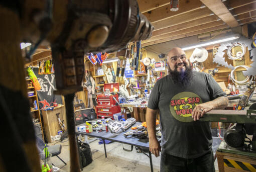 Josh Haazard stands inside his workspace, the HaazLab, where he creates a variety of cosplay props and other creative gadgets Aug. 4 at his home in Monroe.